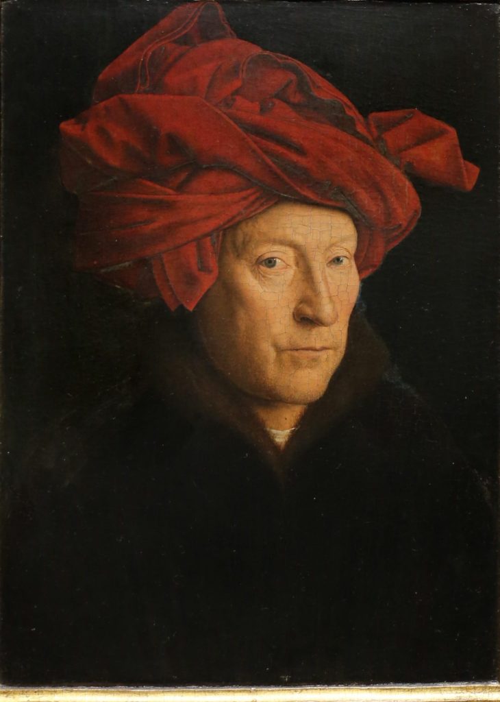 Portrait of a man, possibly a self-portrait by Jan van Eyck from 1433, featuring the artist in a black tunic with a striking red turban, displaying his mastery in capturing human expression and individuality, framed in an ornate golden frame with inscriptions."