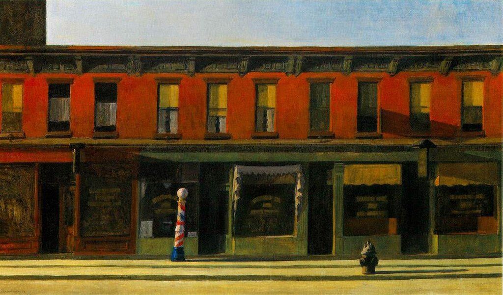 Early Sunday Morning (1930) by Edward Hopper reflects the quiet solitude and stillness of an early morning in urban America.