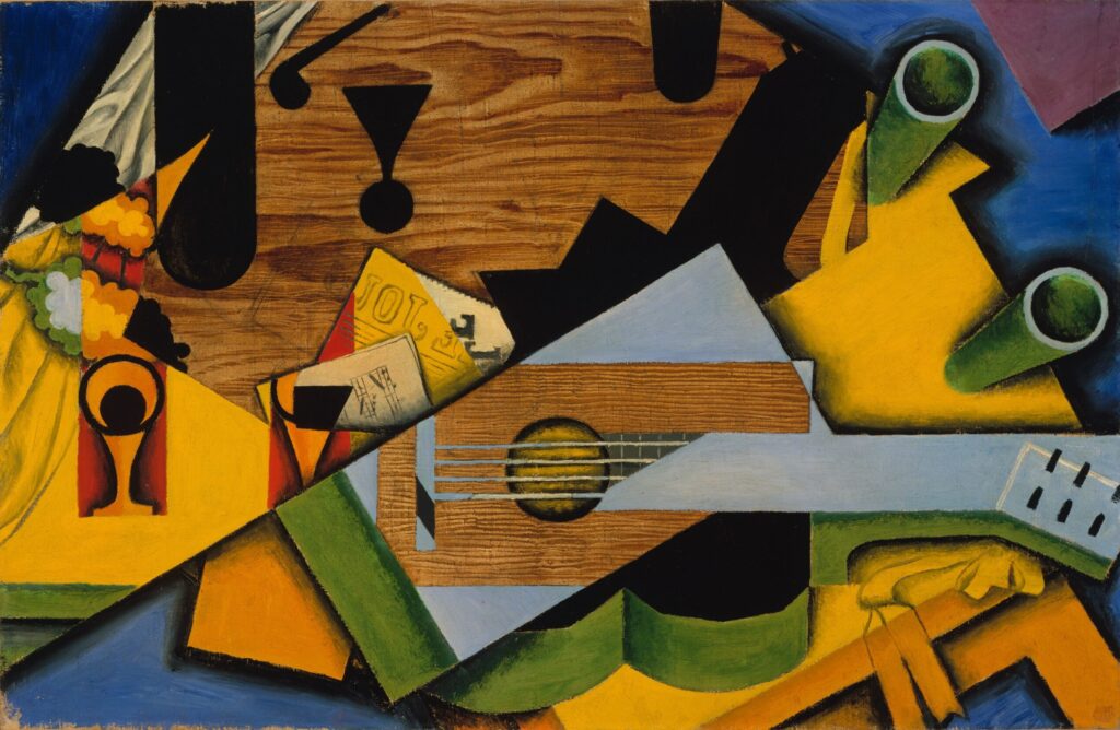 Still Life with a Guitar (1913) by Juan Gris  reflects the early development of Synthetic Cubism.