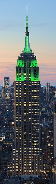 The Empire State Building (1931) illuminated in 2021 reflects the enduring influence of Art Deco design, with its striking vertical lines and monumental scale
