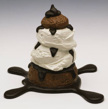 Profiterole (1990) reflects a large-scale, soft sculpture of a popular pastry, the profiterole, often known as a cream puff