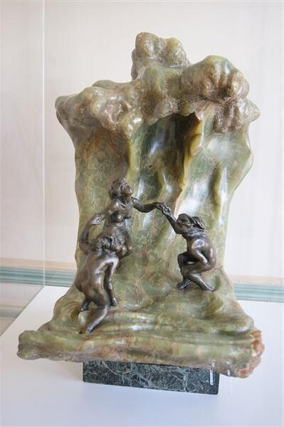 The Wave (1897) by Camille Claudel reflects a dynamic fusion of human figures and natural forces, depicting three female bathers caught in the motion of an impending wave